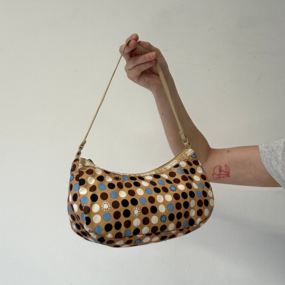 tanned blue polka dot canvas mini shoulder bag