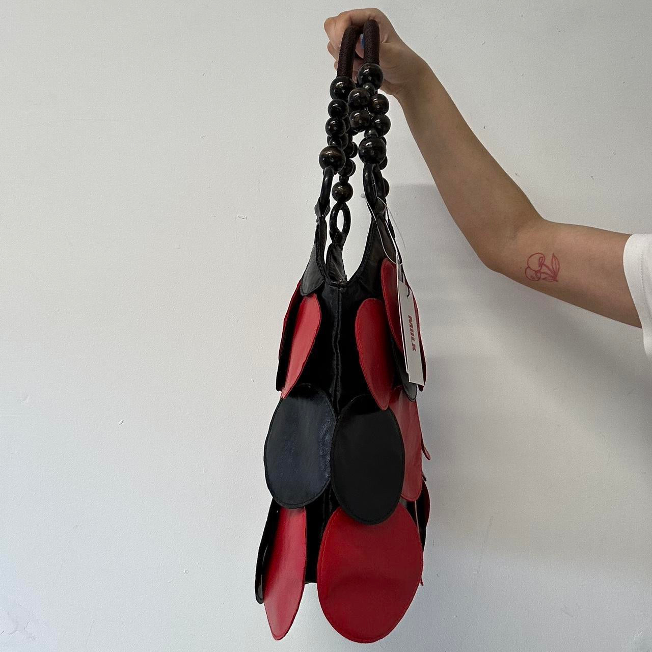 black and red faux leather disc shoulder bag
