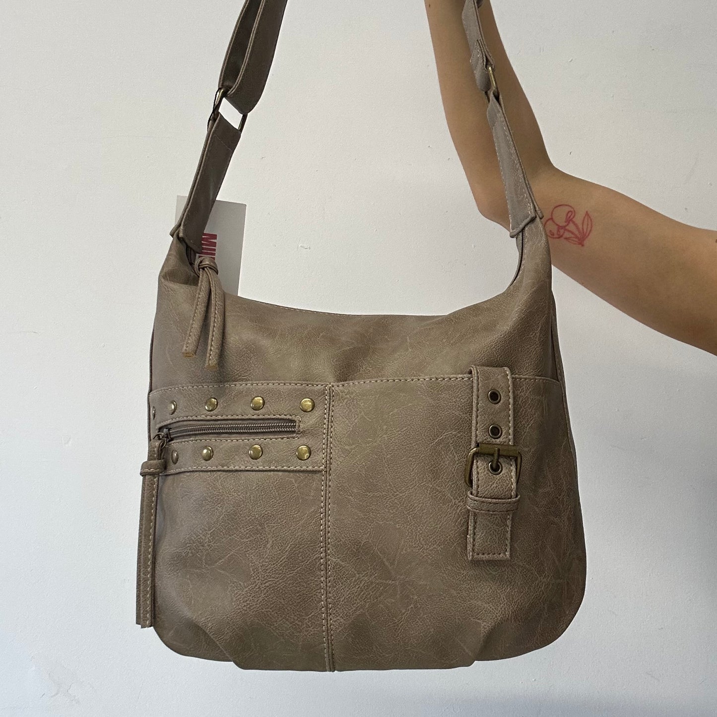 light brown buckle and studded cross body / shoulder bag
