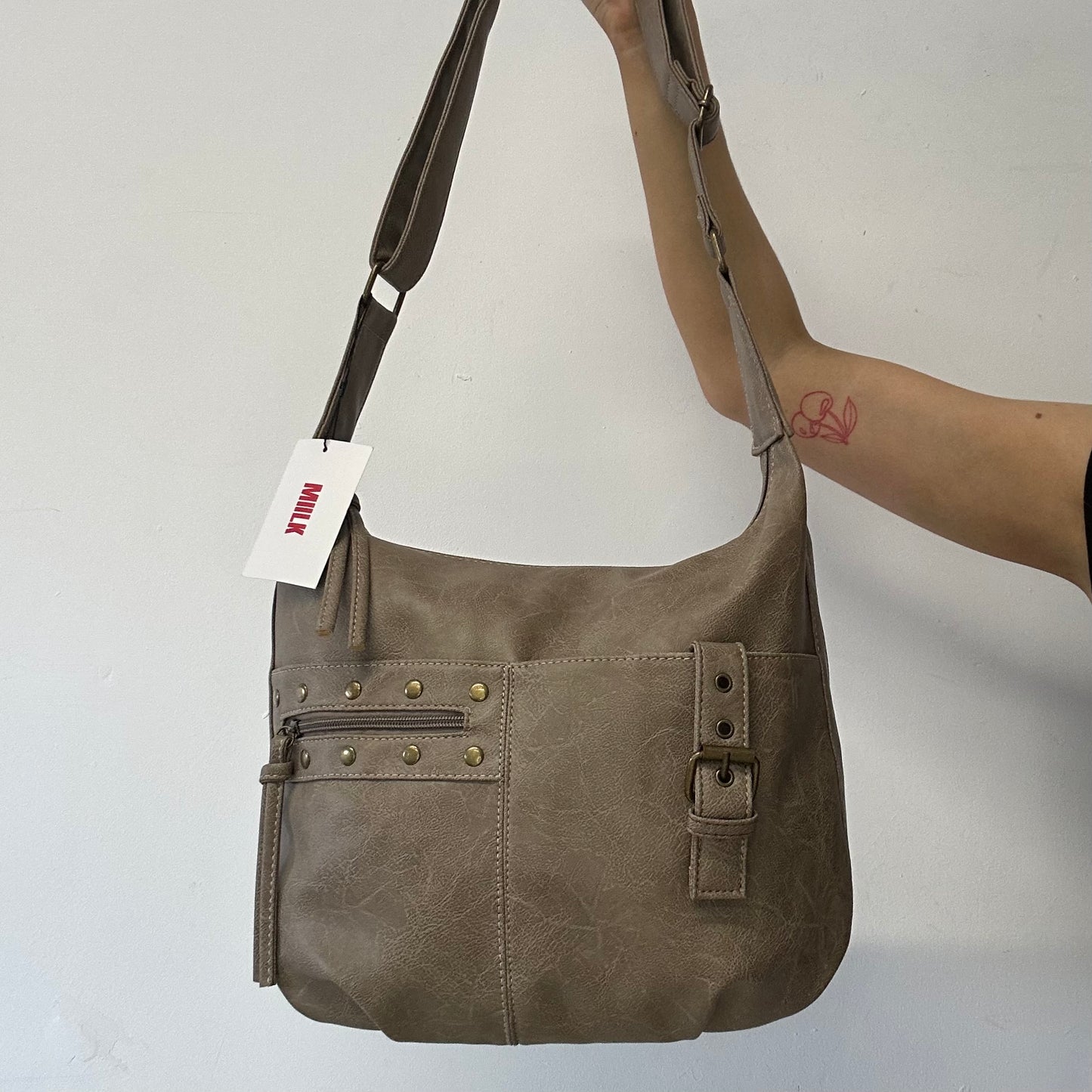 light brown buckle and studded cross body / shoulder bag