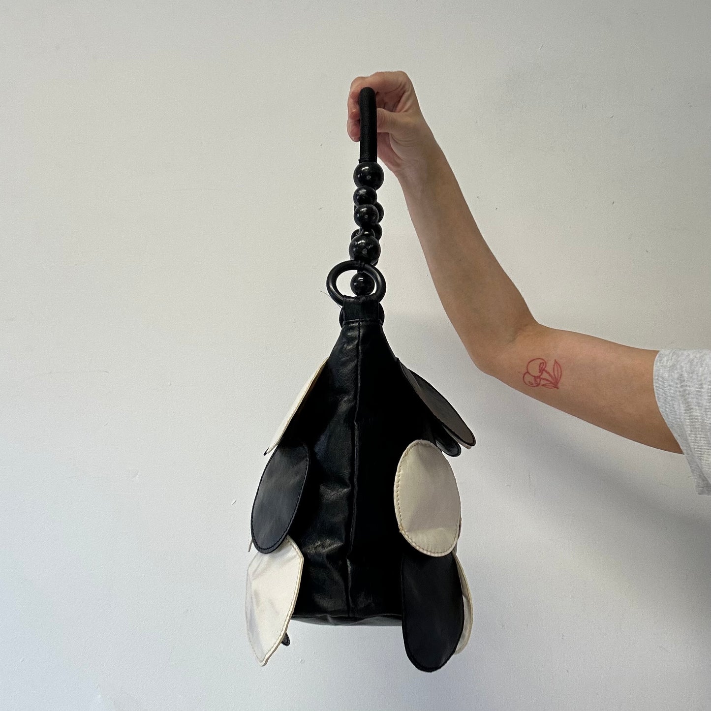 black and white faux leather disc beaded shoulder bag