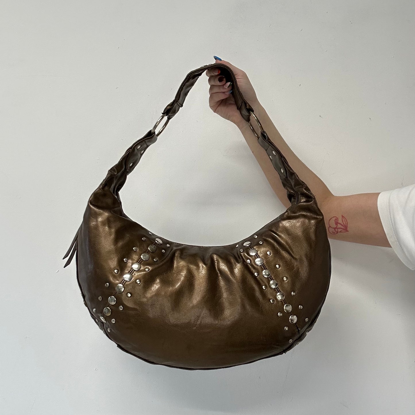 brown studded faux leather half crescent shoulder bag