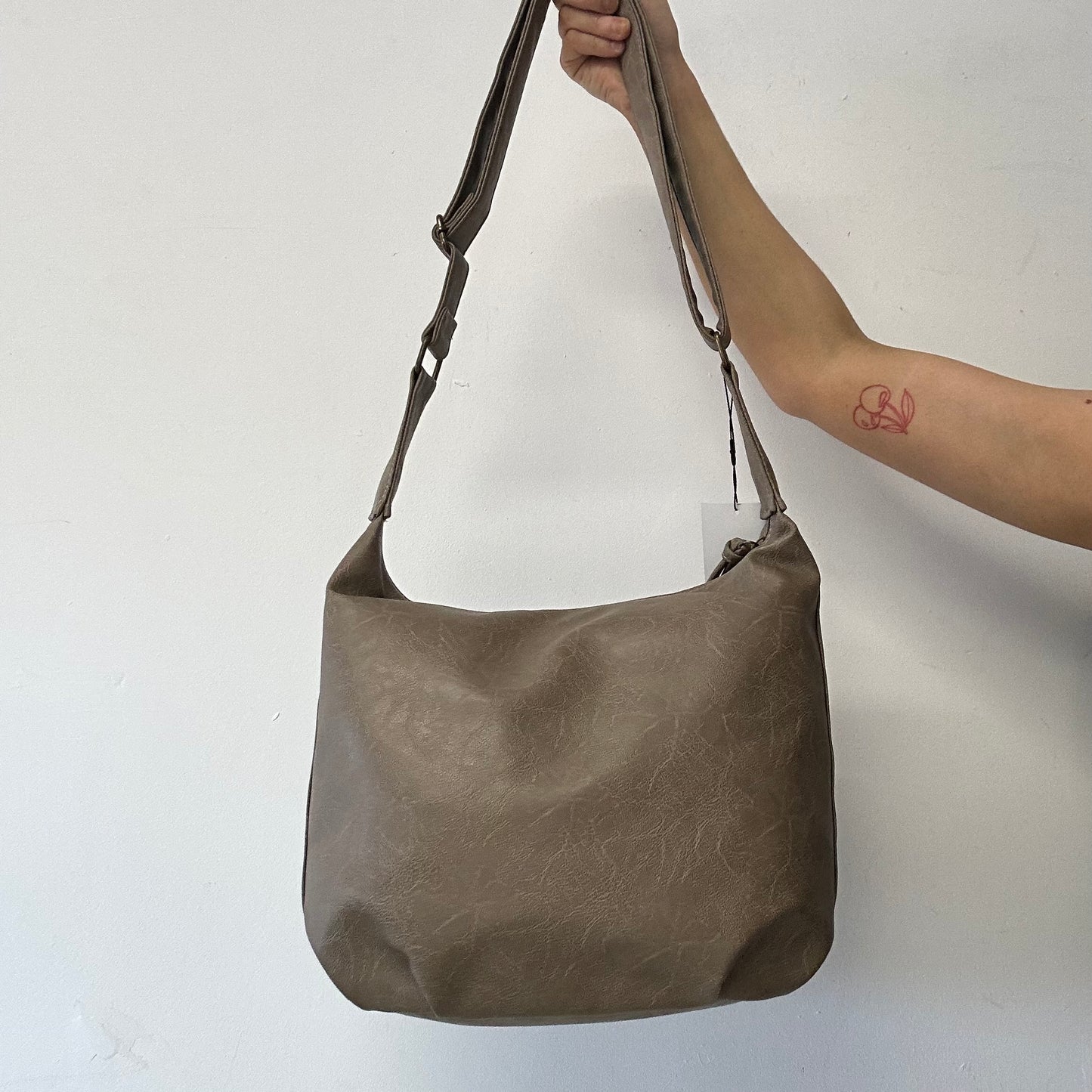 light brown buckle and studded cross body / shoulder bag