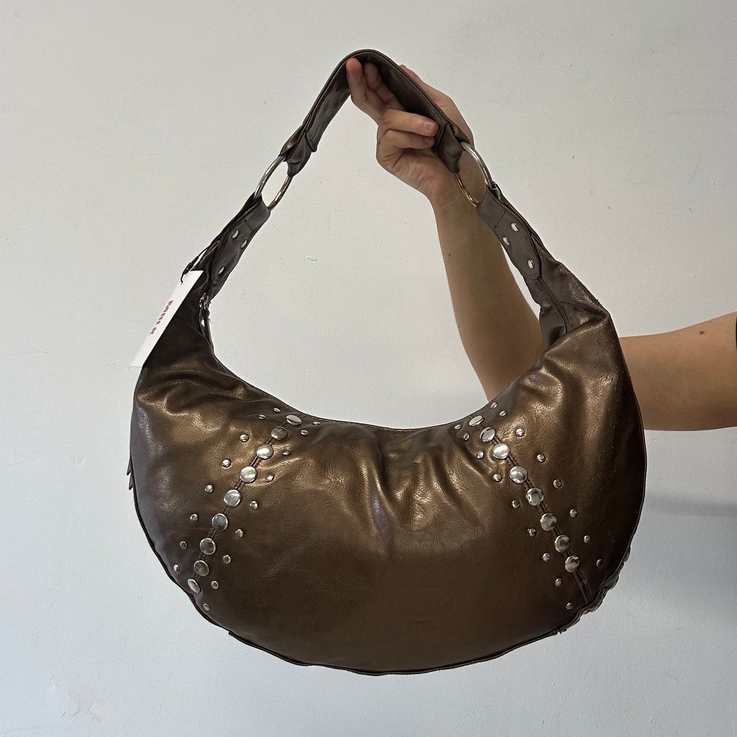 brown studded crescent faux leather shoulder bag