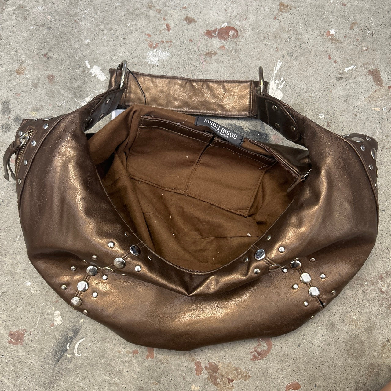 brown studded crescent faux leather shoulder bag