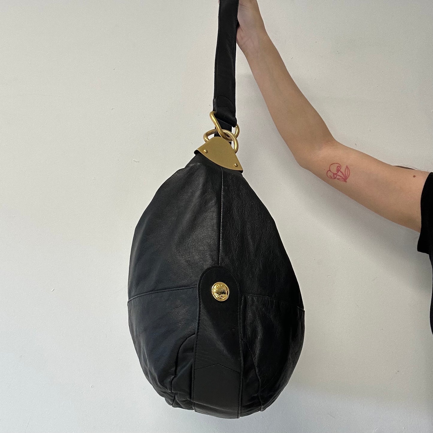 black faux leather large sling bag
