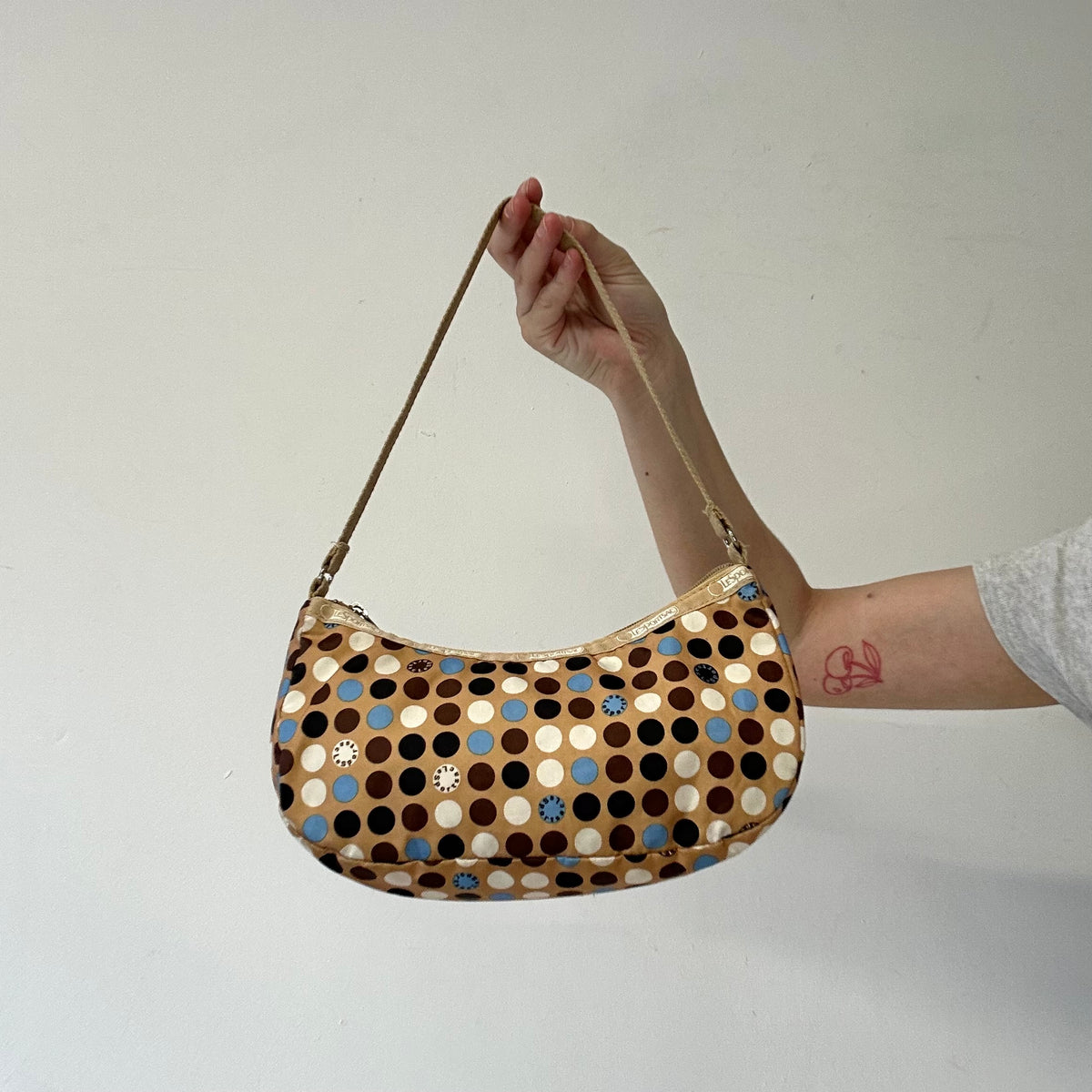 tanned blue polka dot canvas mini shoulder bag