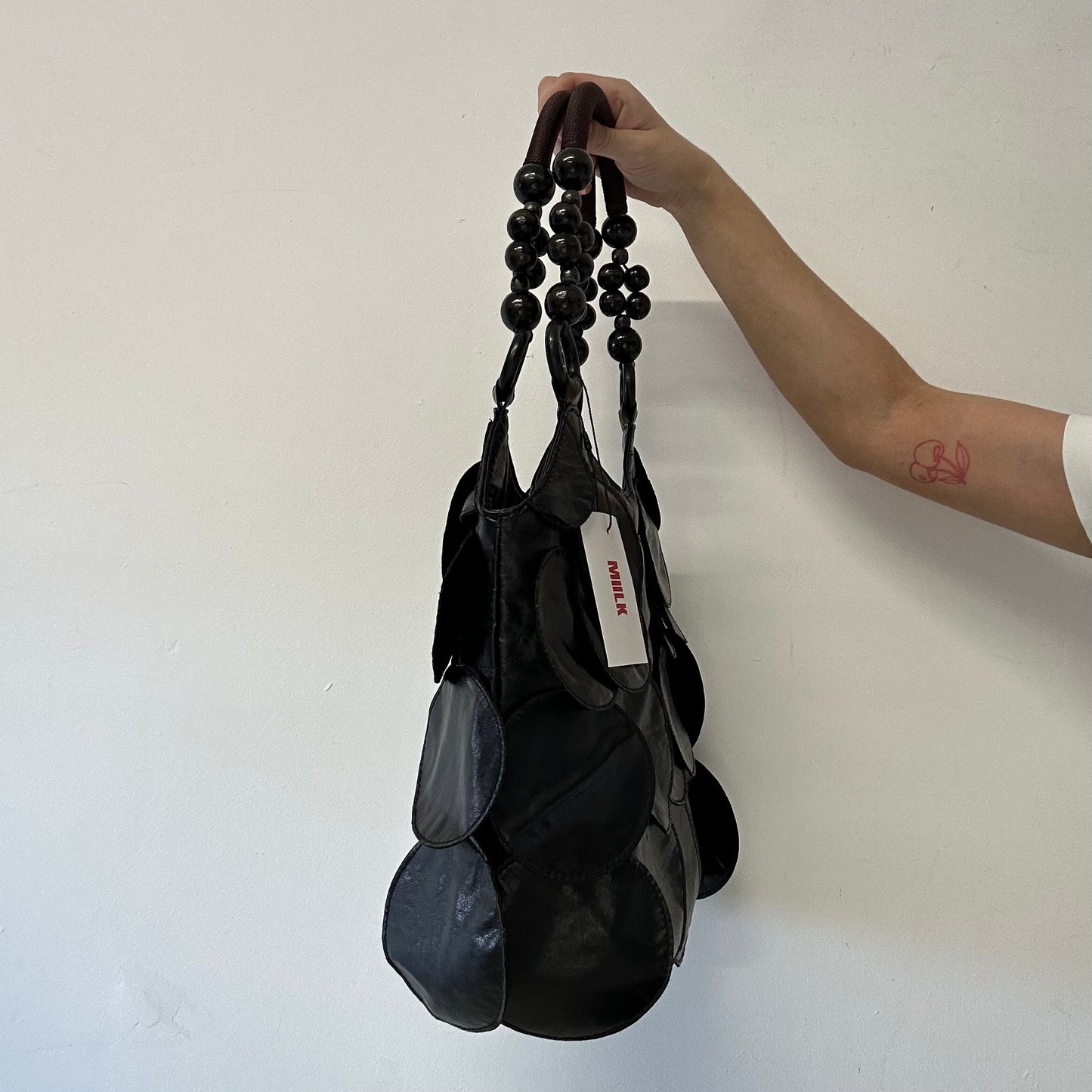 black faux leather disc beaded shoulder bag