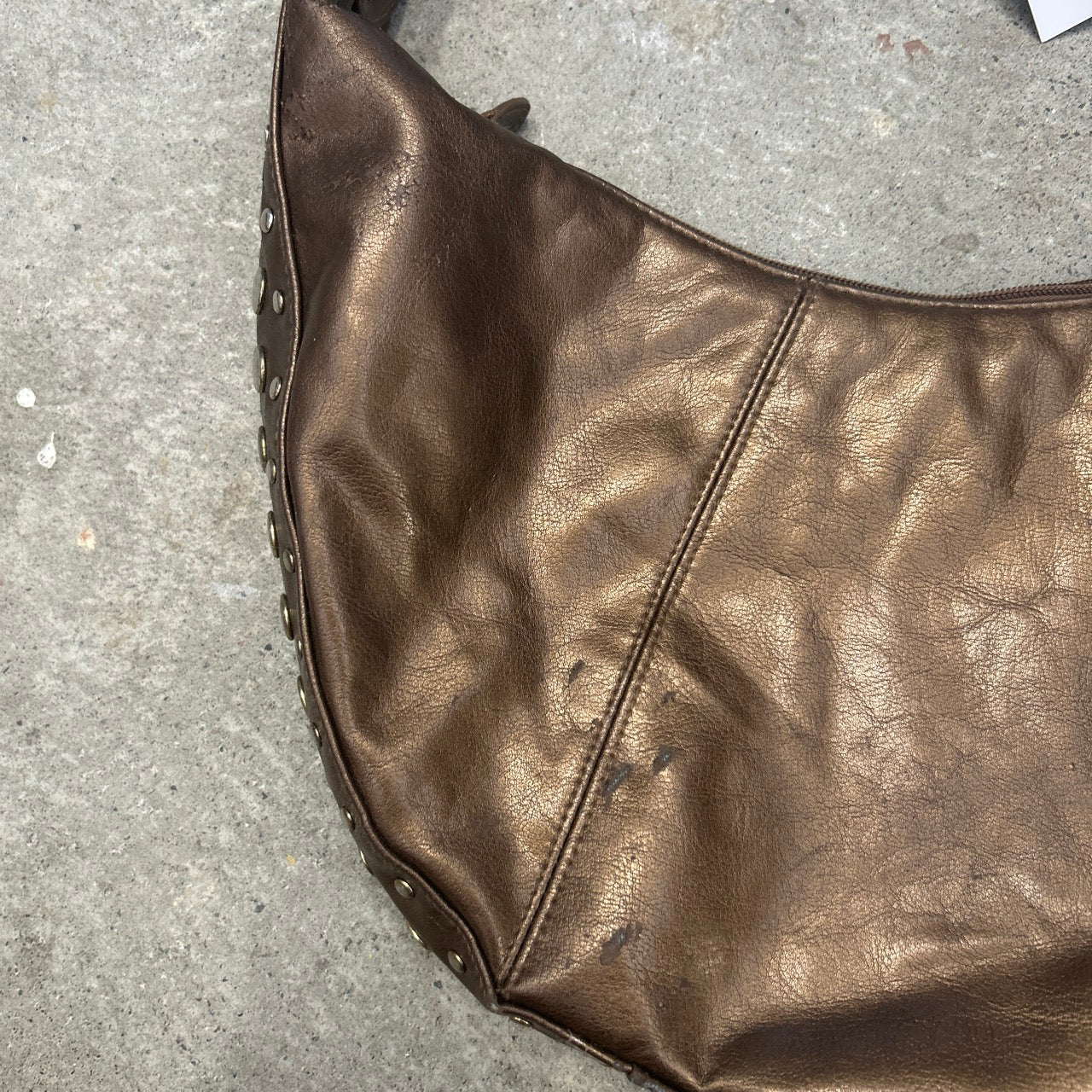 brown studded crescent faux leather shoulder bag
