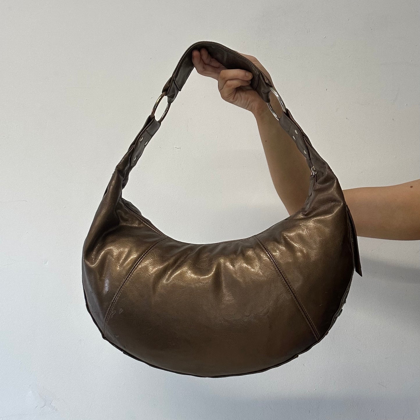 brown studded crescent faux leather shoulder bag