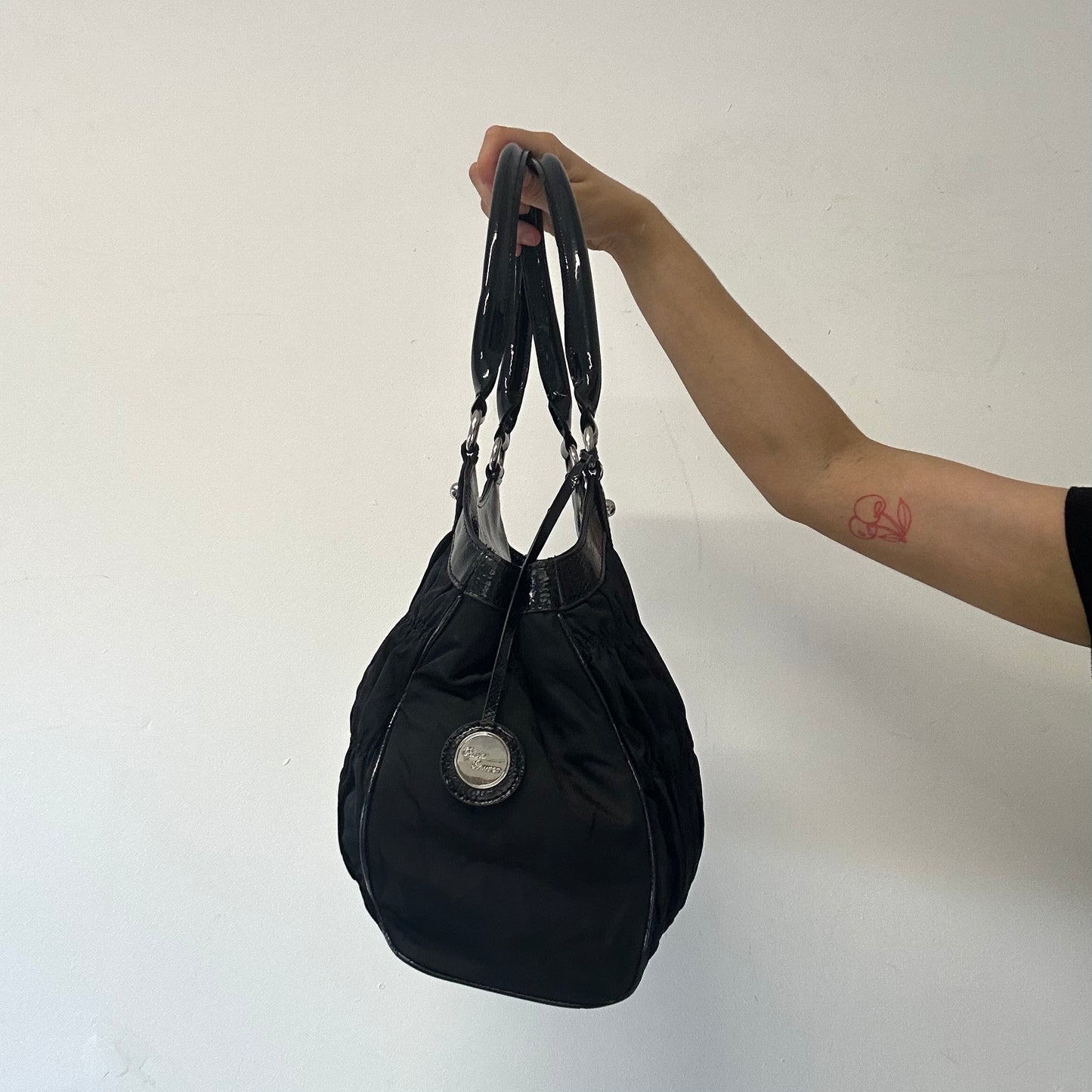 black ruched canvas and faux leather shoulder bag