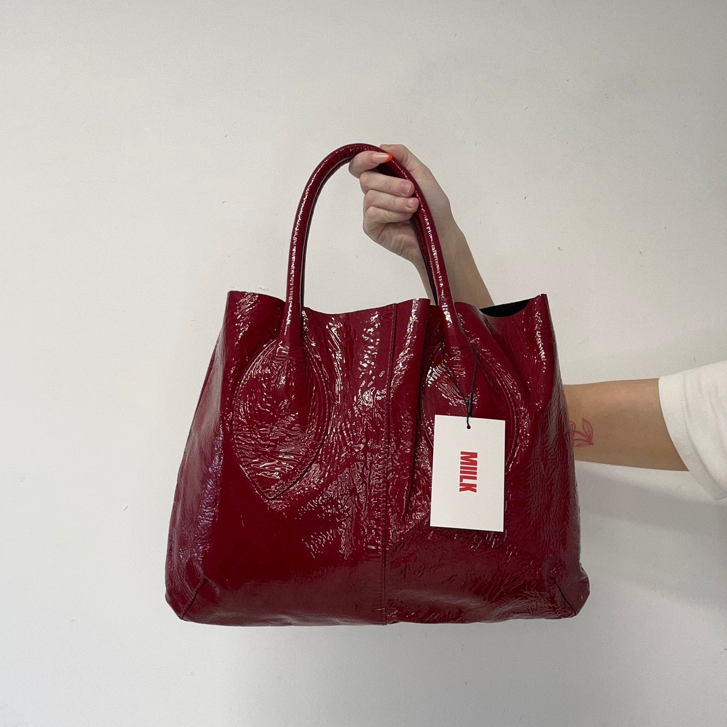 red lightweight patent shoulder bag