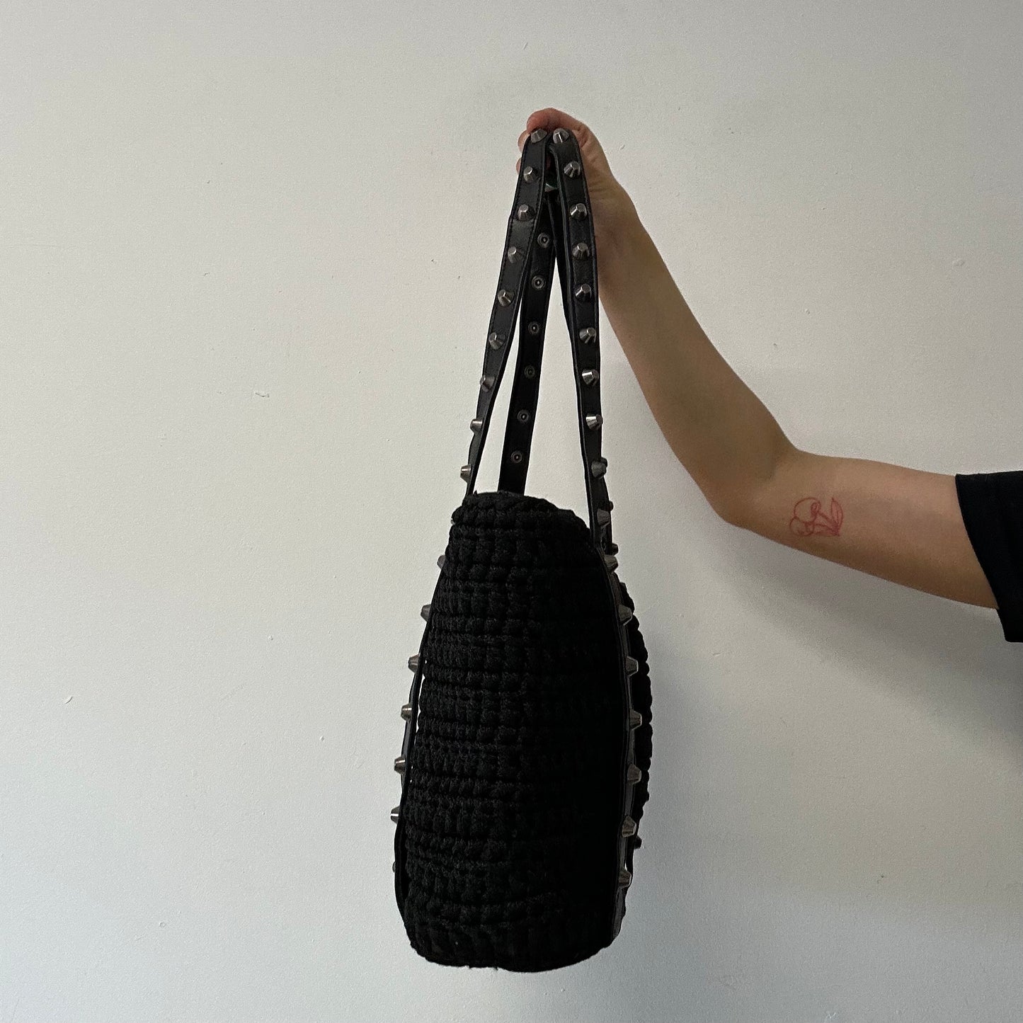 black woven studded shoulder bag