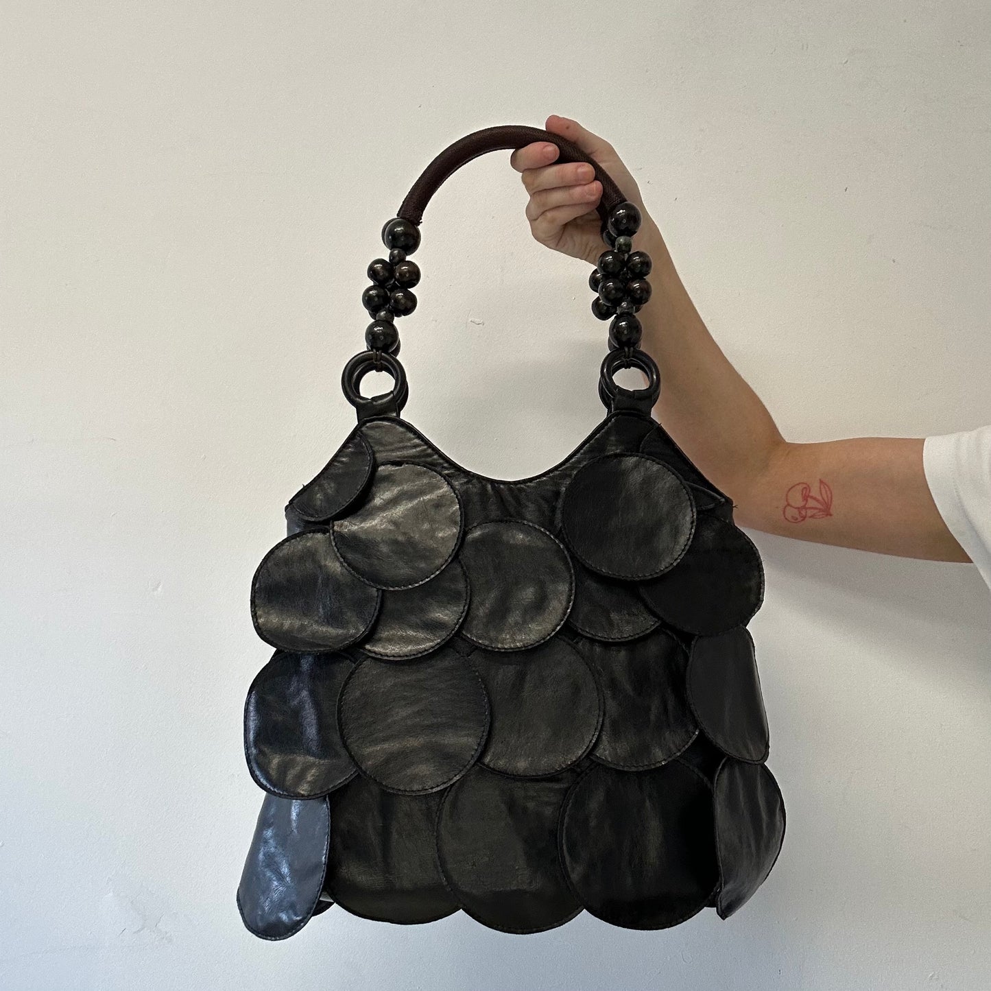 black faux leather disc beaded shoulder bag