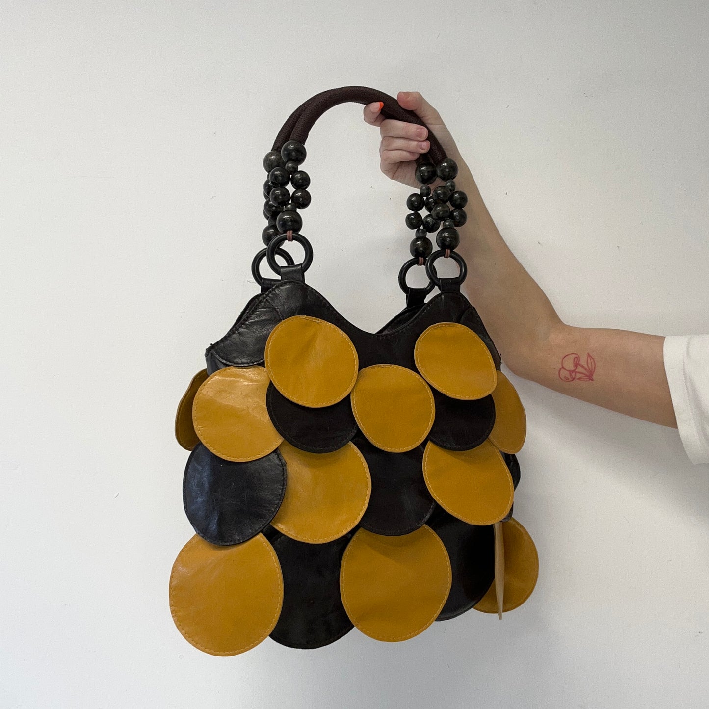 yellow and black faux leather disc beaded shoulder bag
