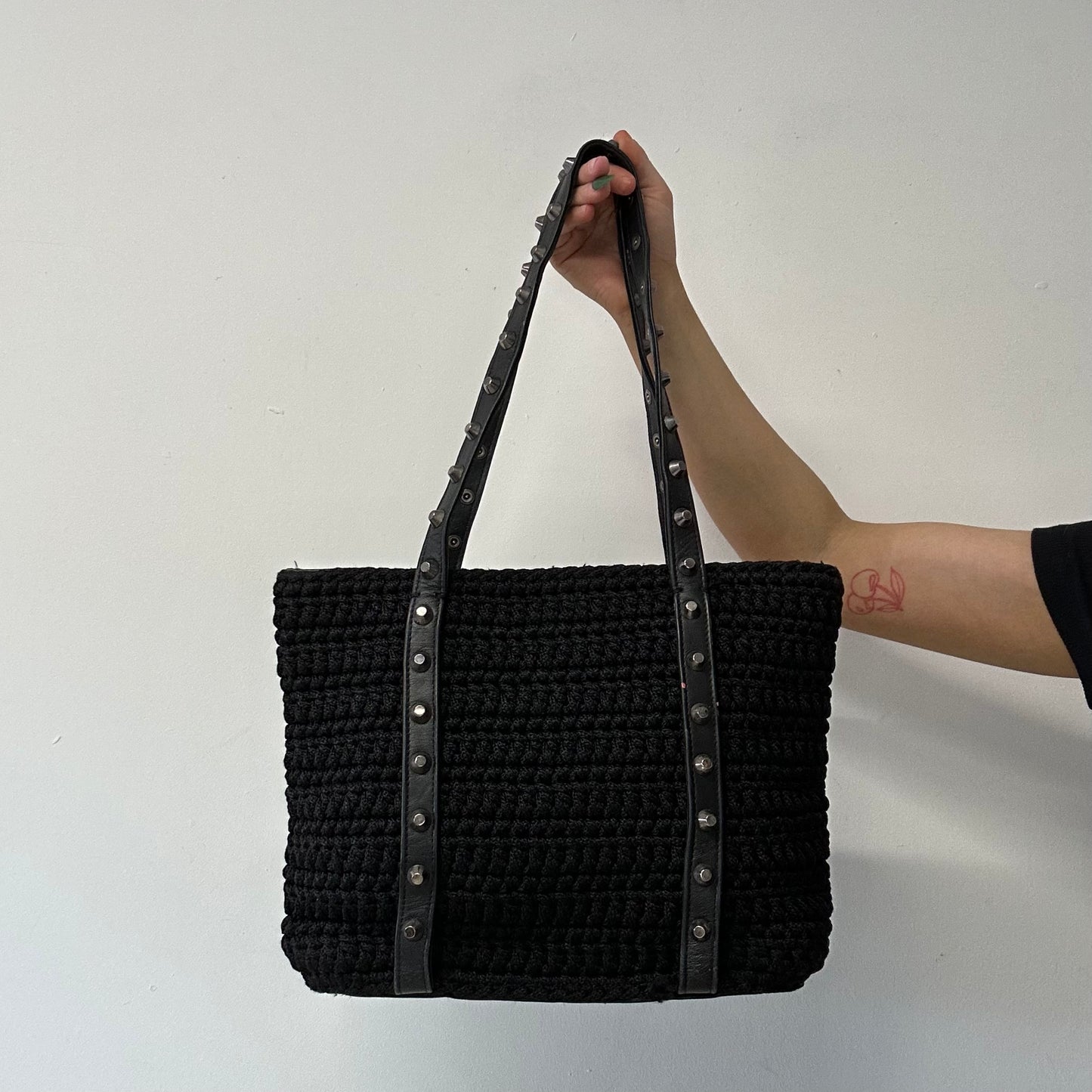 black woven studded shoulder bag