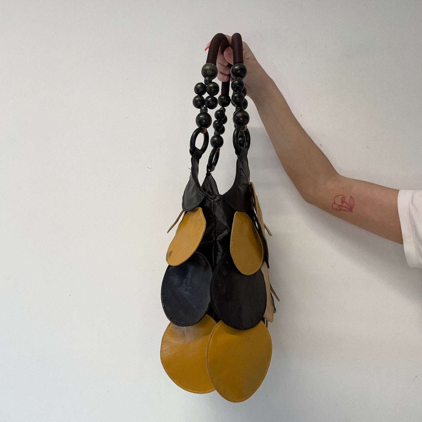 yellow and black faux leather disc beaded shoulder bag