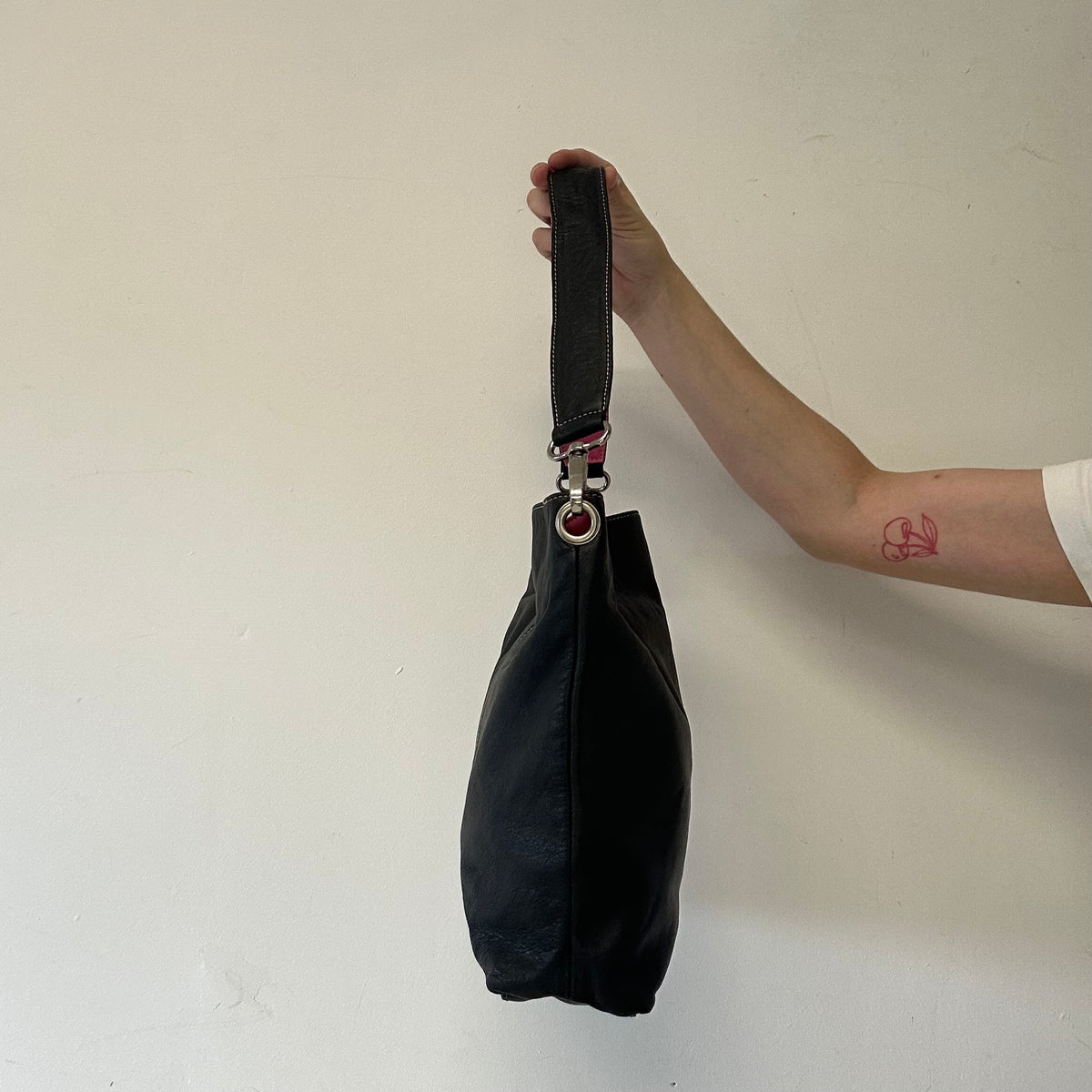 black and pink “J”  faux leather shoulder bag