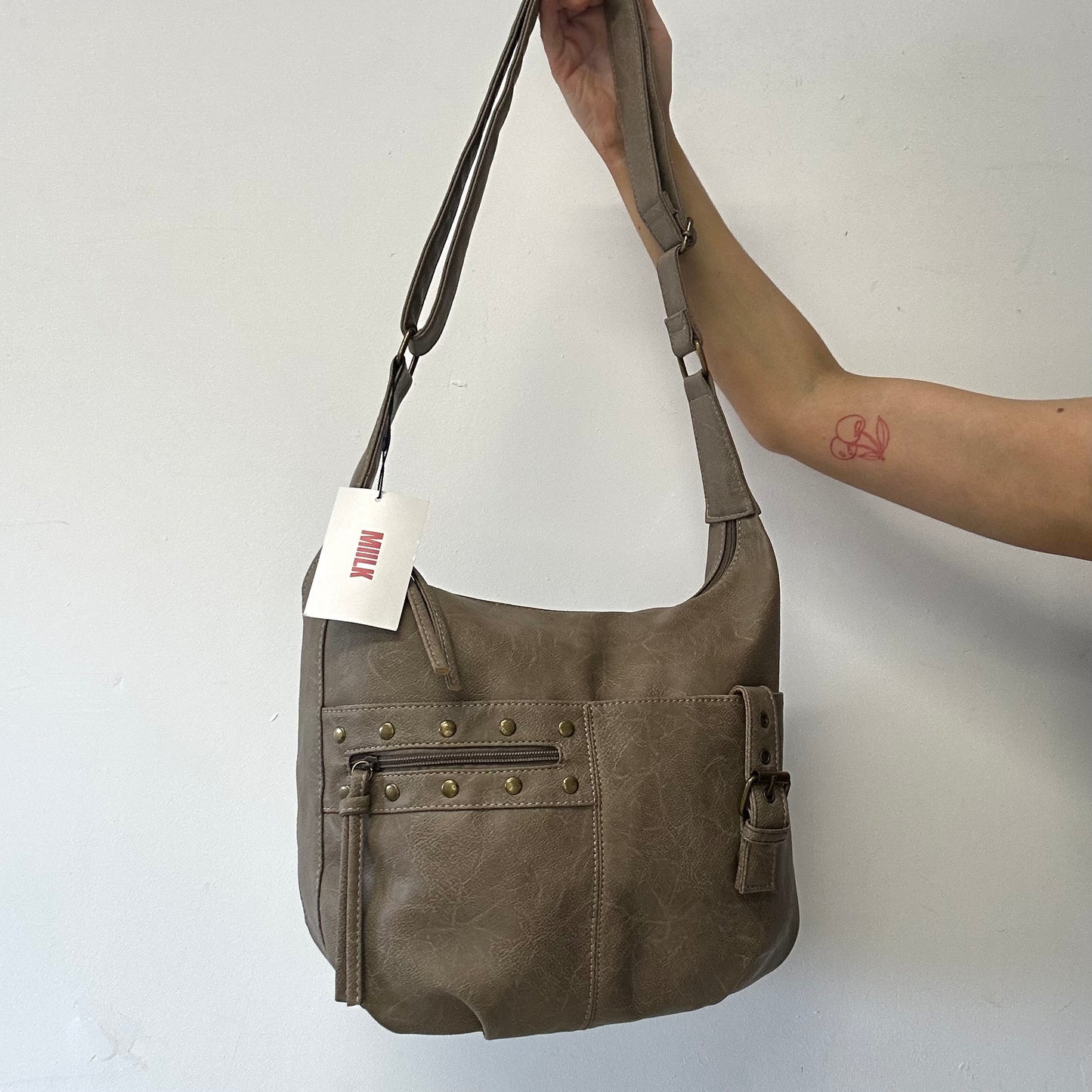 light brown buckle and studded cross body / shoulder bag