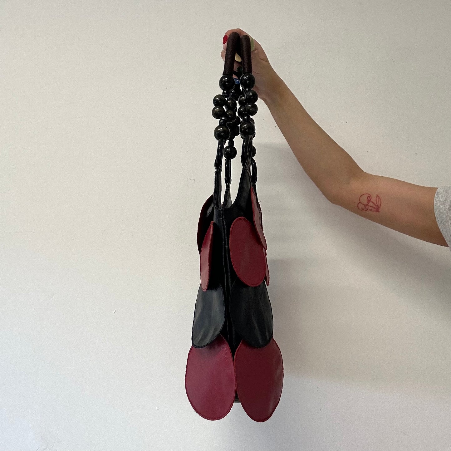red and black faux leather disc beaded shoulder bag