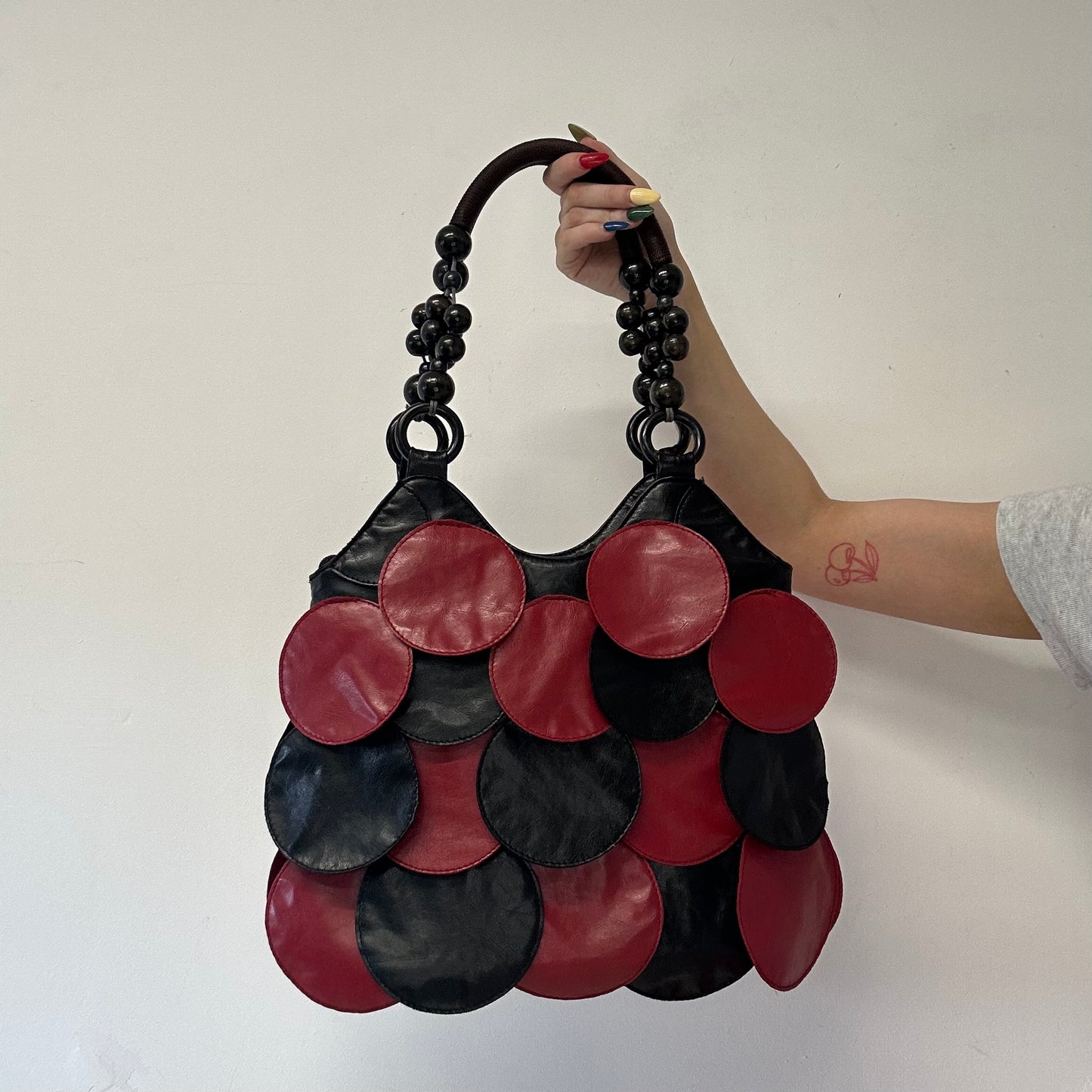 red and black faux leather disc beaded shoulder bag
