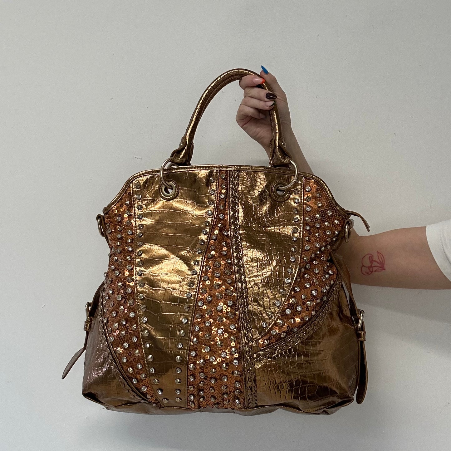 gold and bronze studded croc effect hand bag