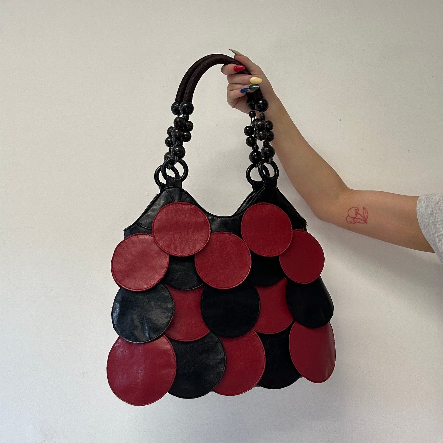 red and black faux leather disc beaded shoulder bag