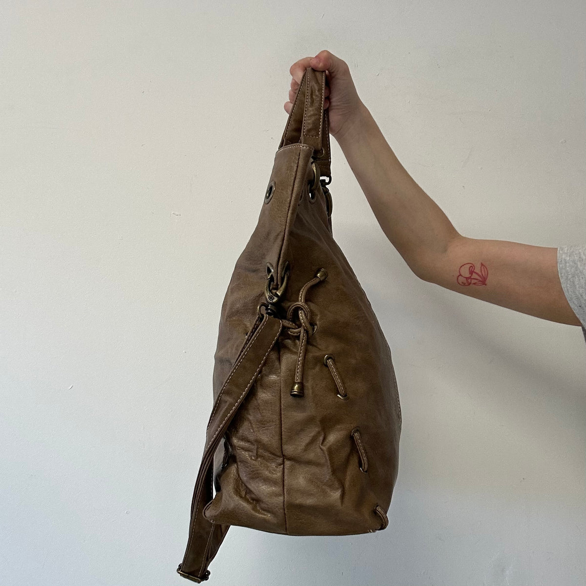 brown eyelet ruched sides faux leather shoulder bag