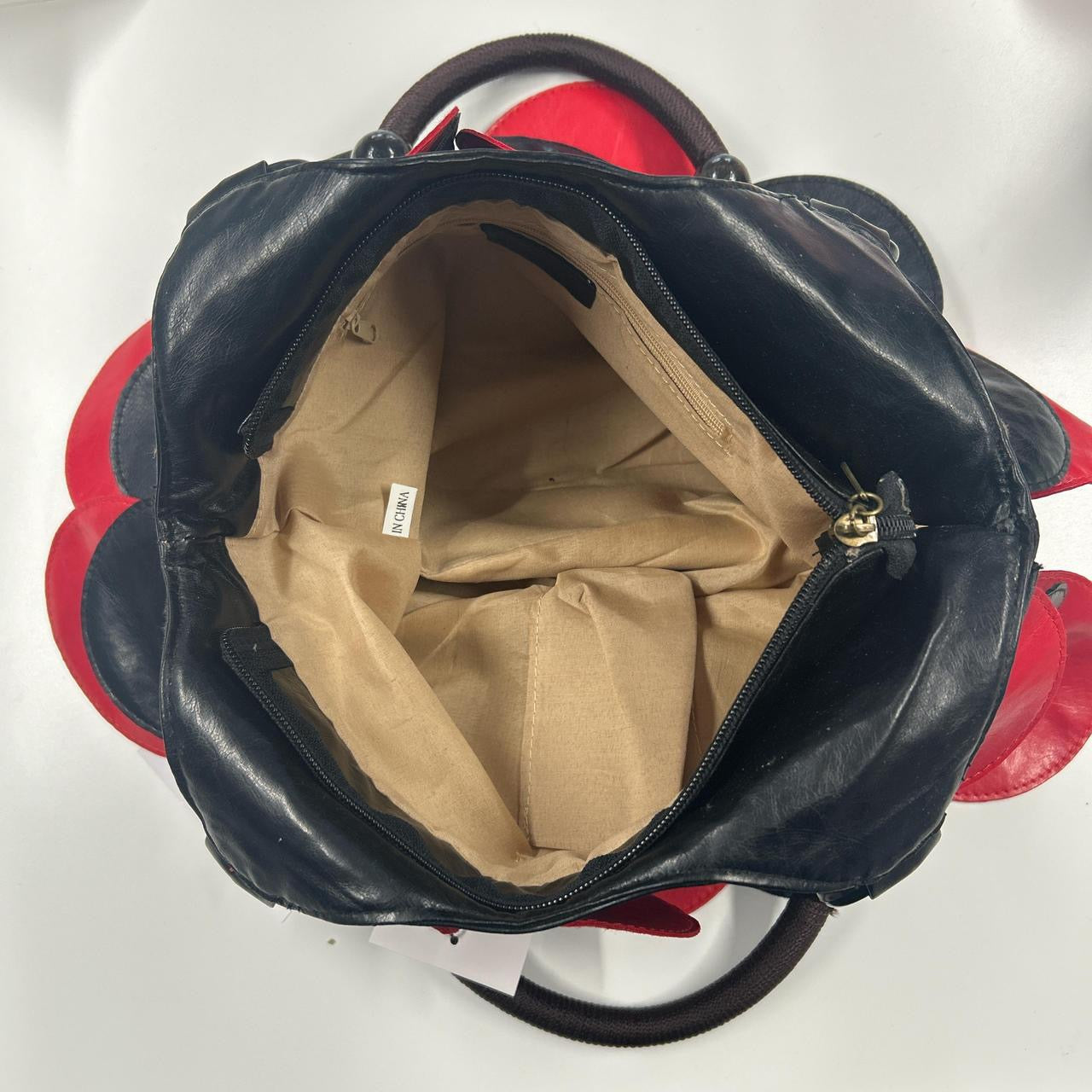 black and red faux leather disc shoulder bag