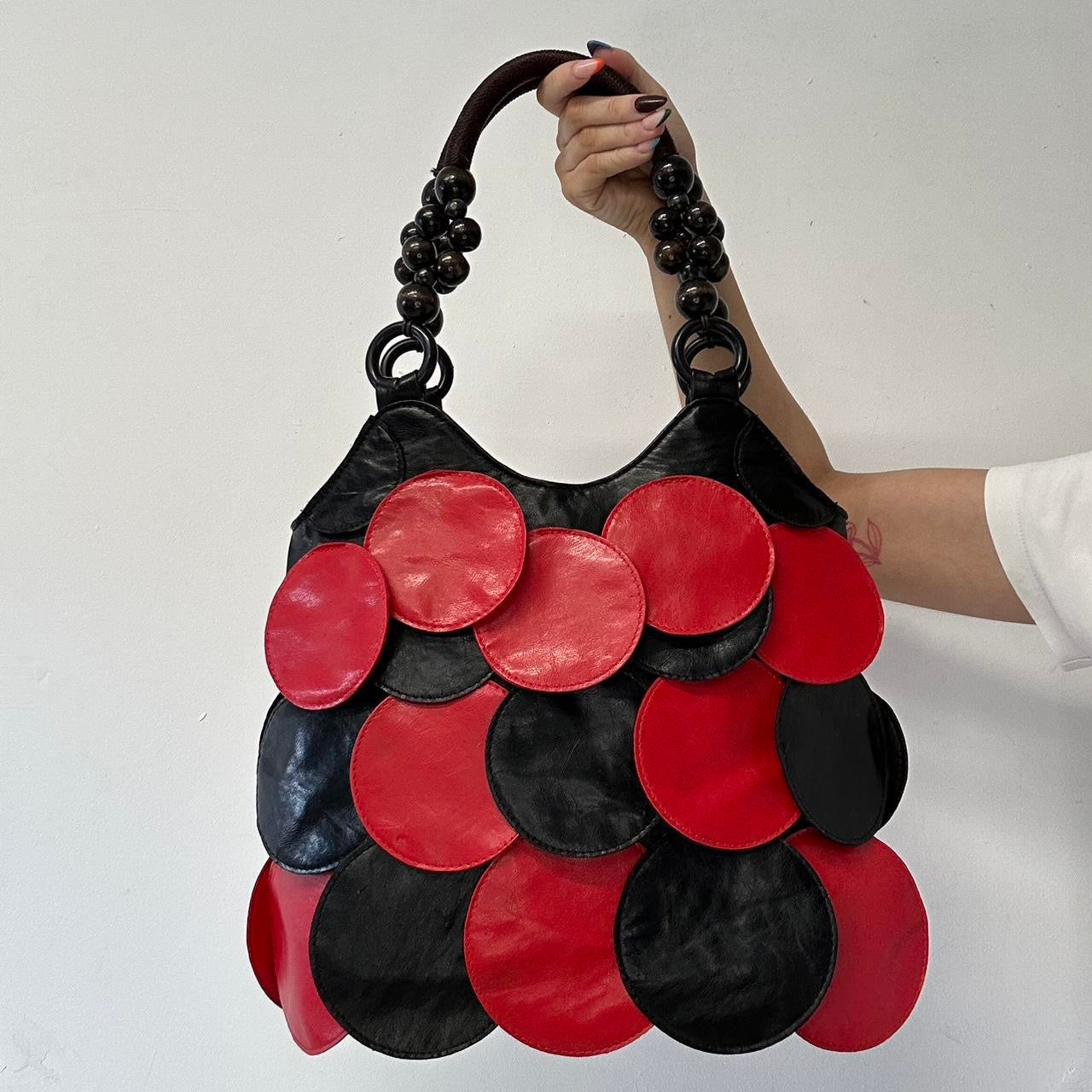 black and red faux leather disc shoulder bag