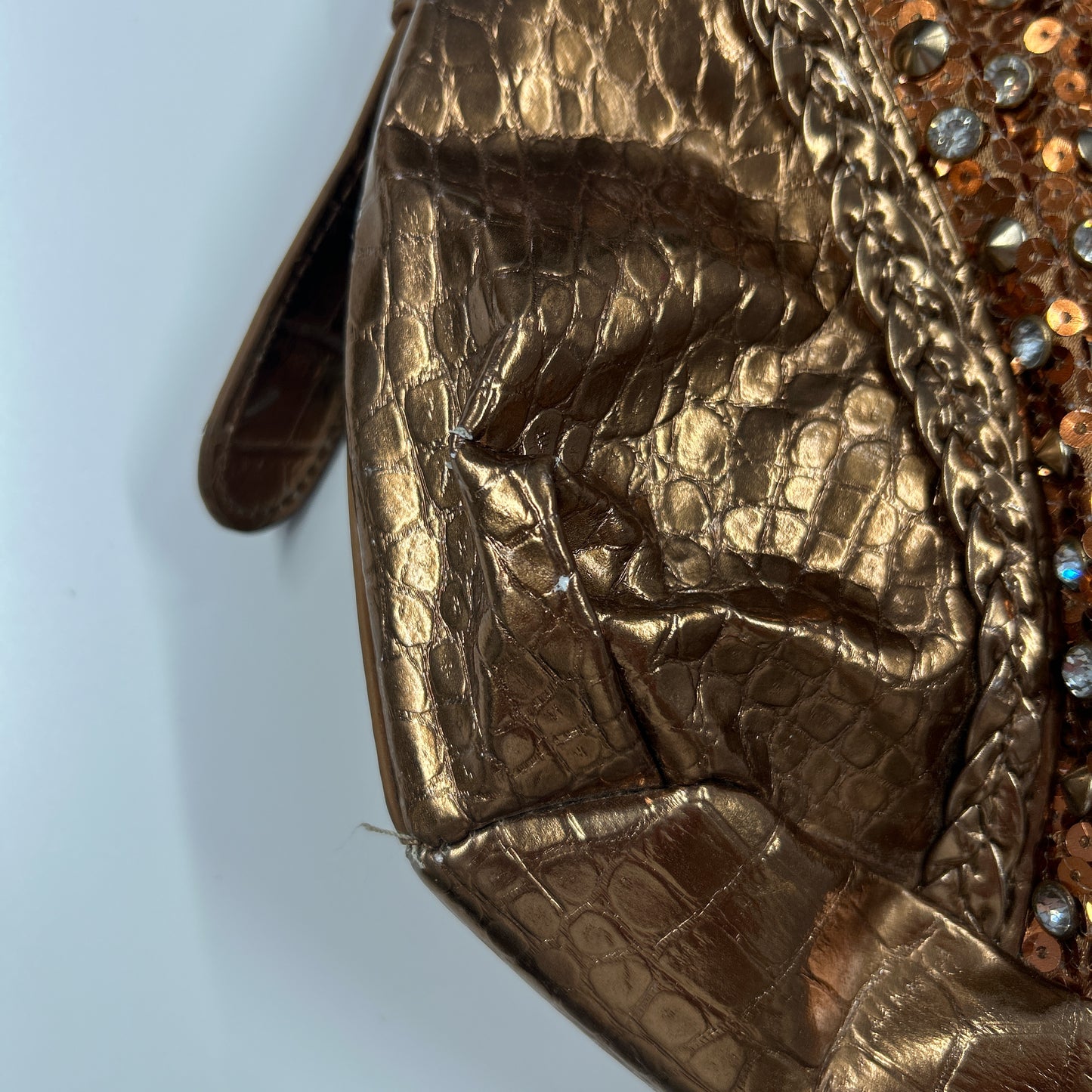 gold and bronze studded croc effect hand bag