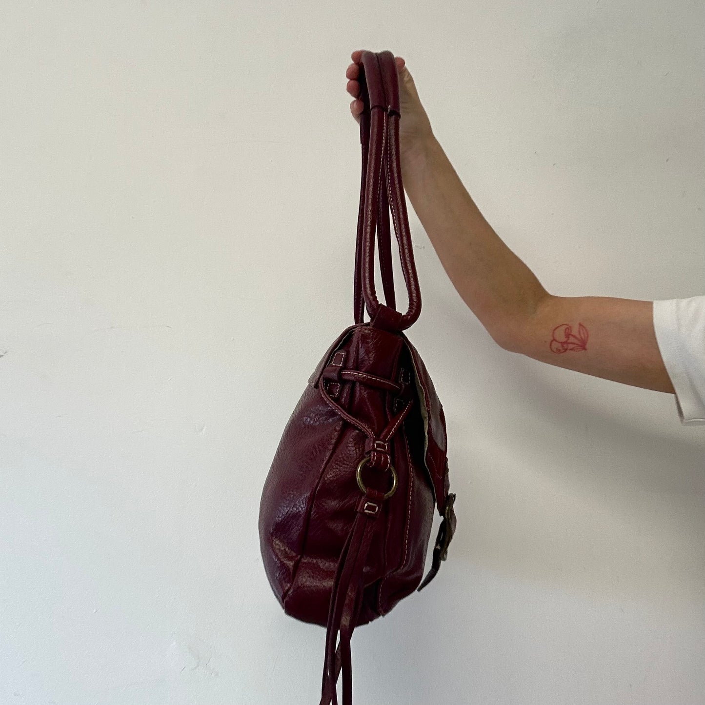 dark red faux leather western buckle shoulder bag