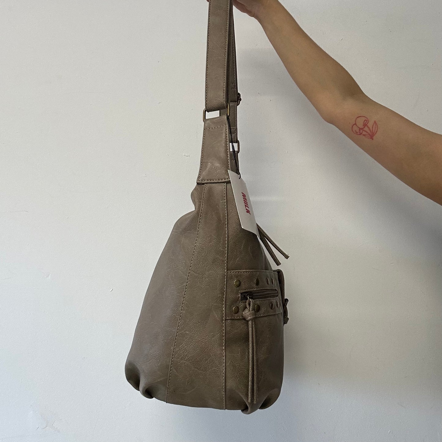 light brown buckle and studded cross body / shoulder bag