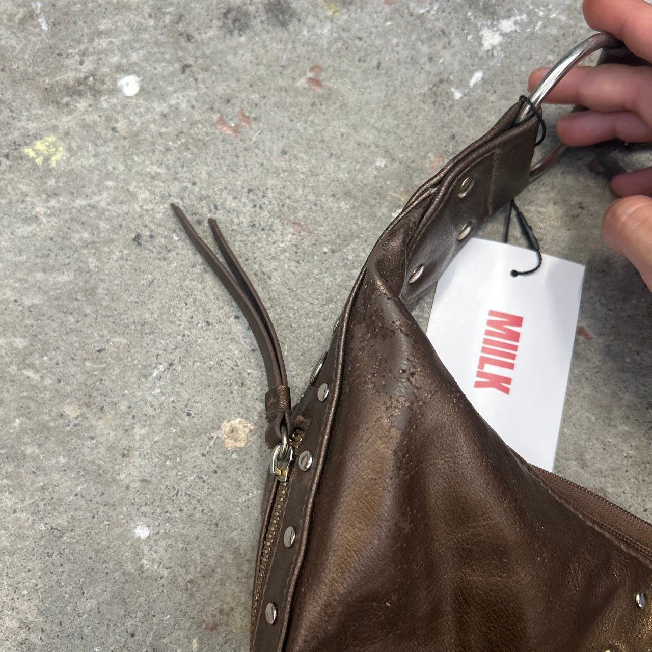 brown studded crescent faux leather shoulder bag