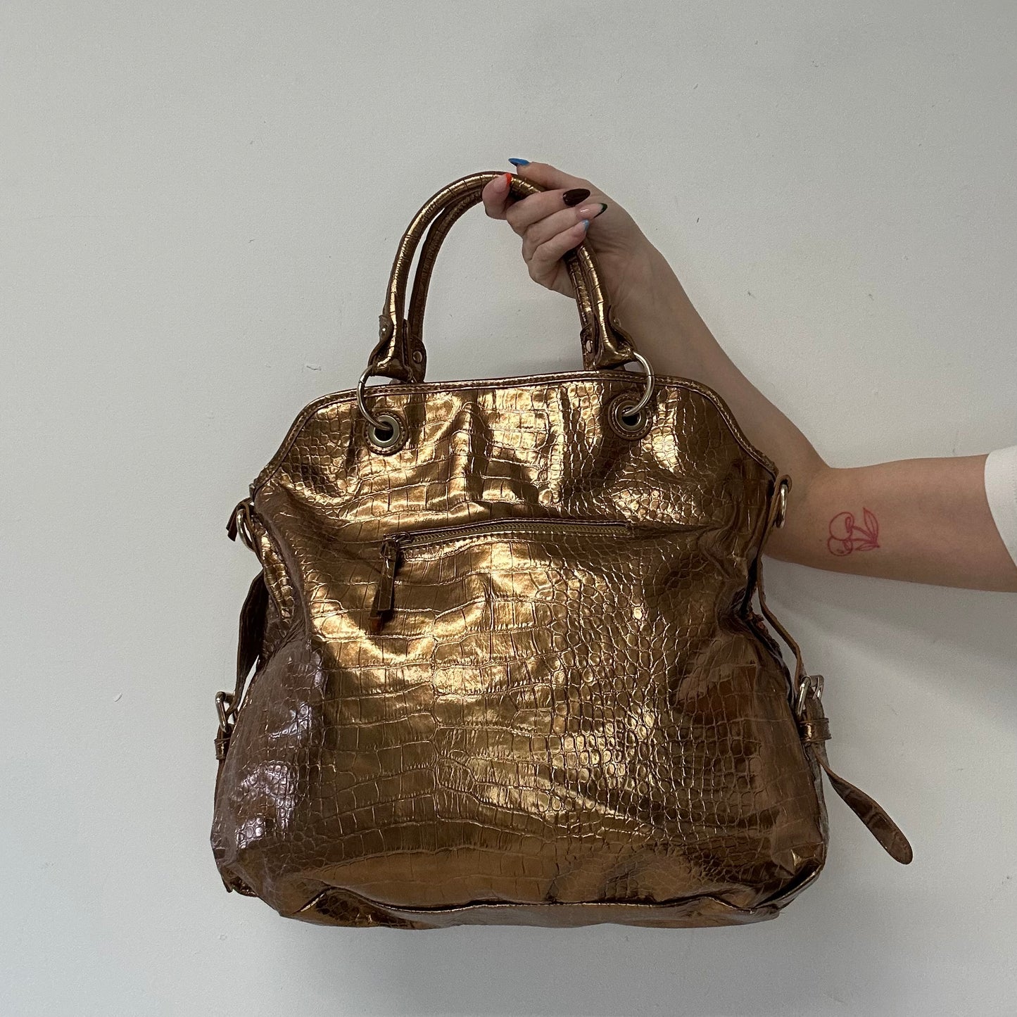 gold and bronze studded croc effect hand bag