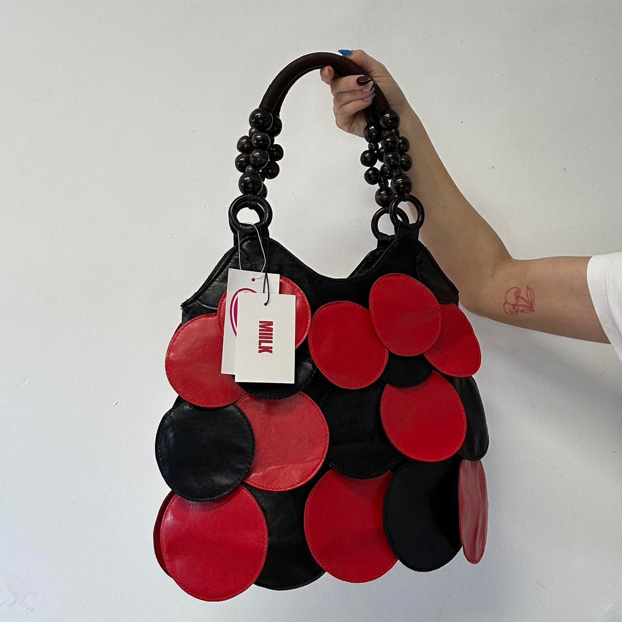 black and red faux leather disc shoulder bag
