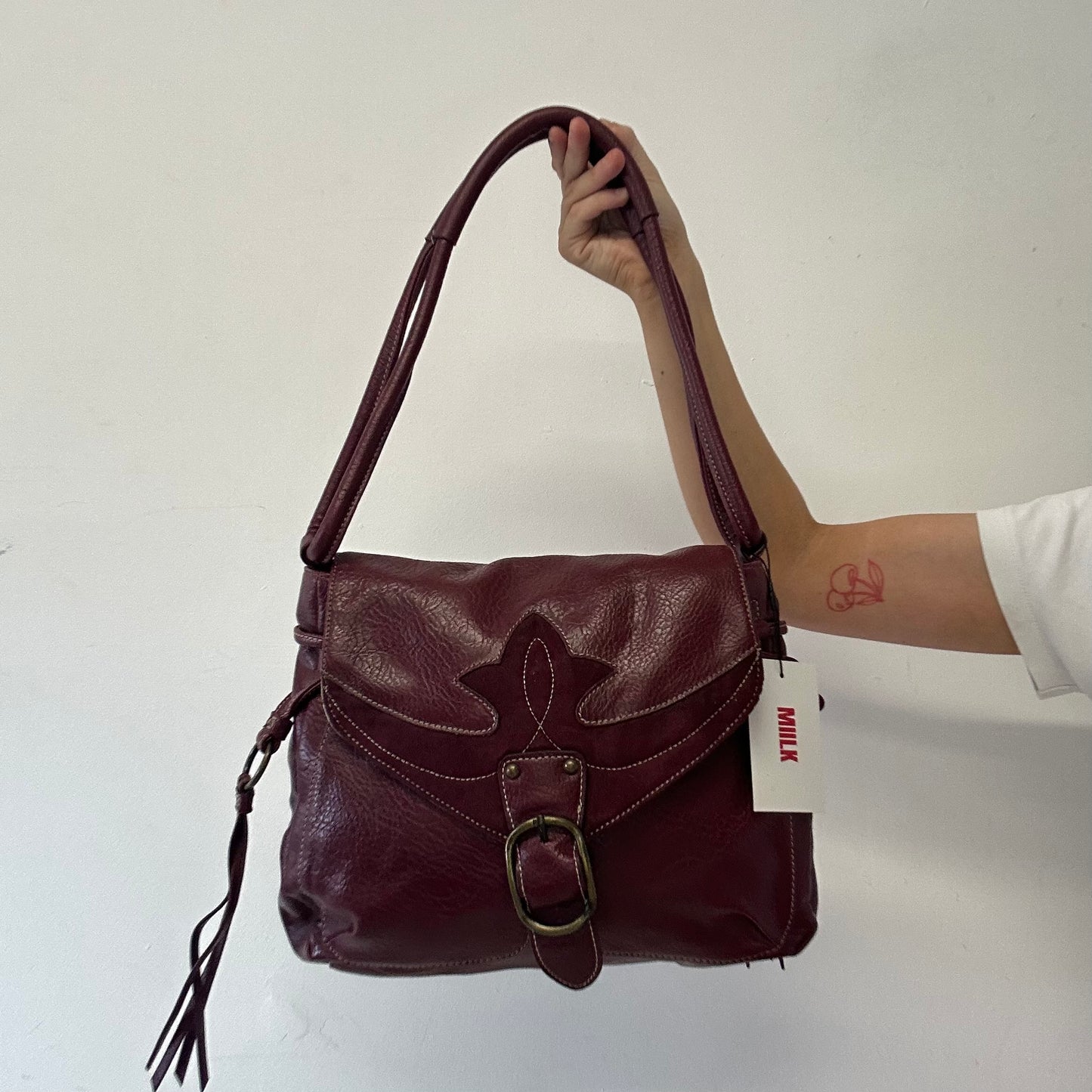 dark red faux leather western buckle shoulder bag