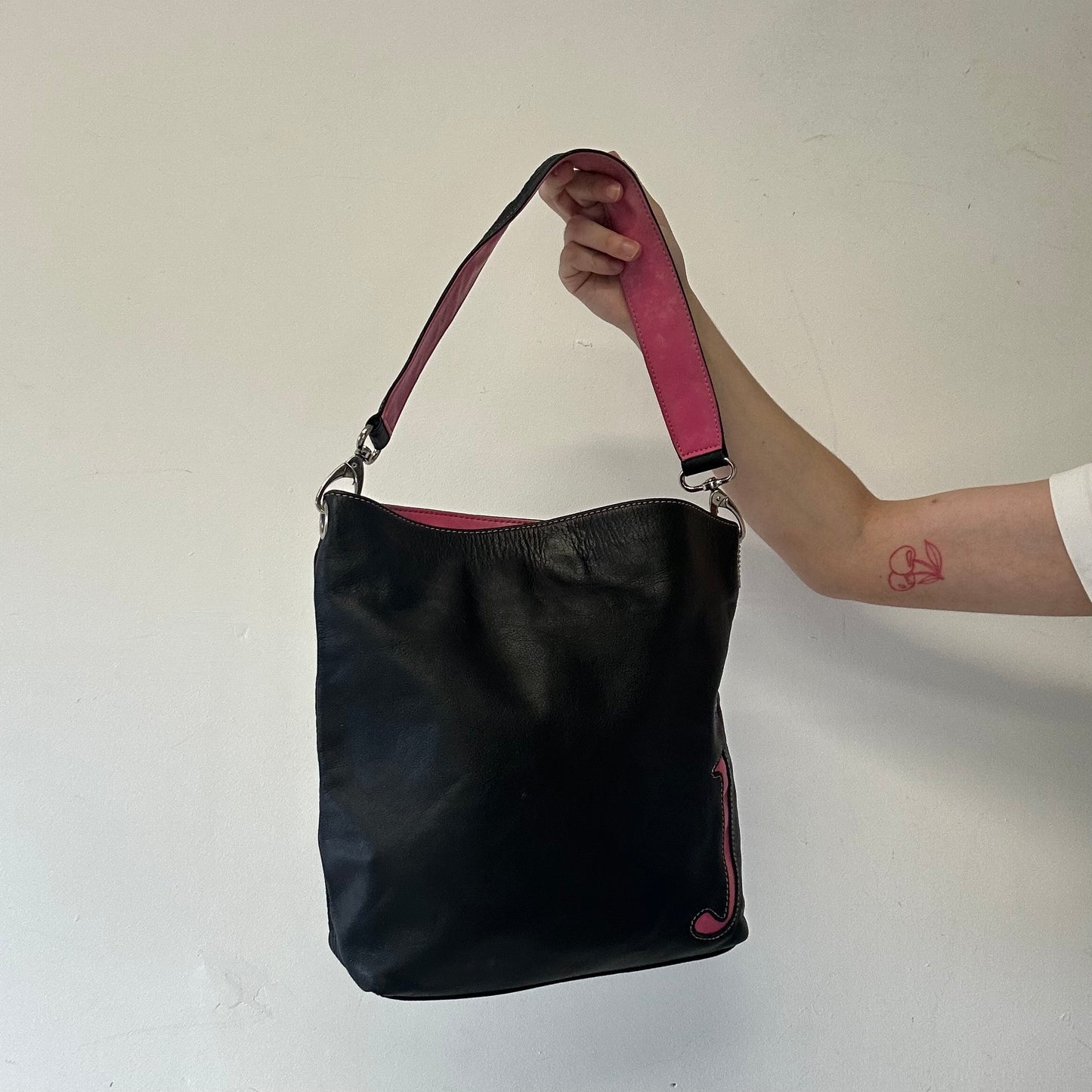 black and pink “J”  faux leather shoulder bag