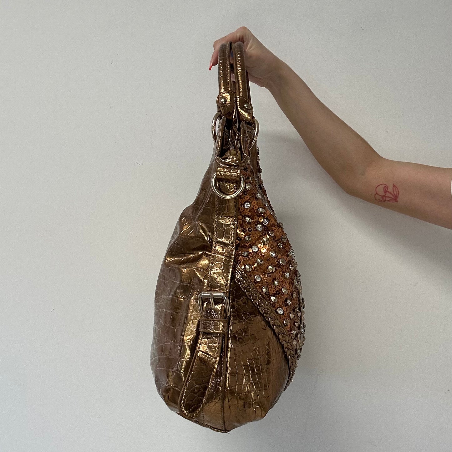 gold and bronze studded croc effect hand bag