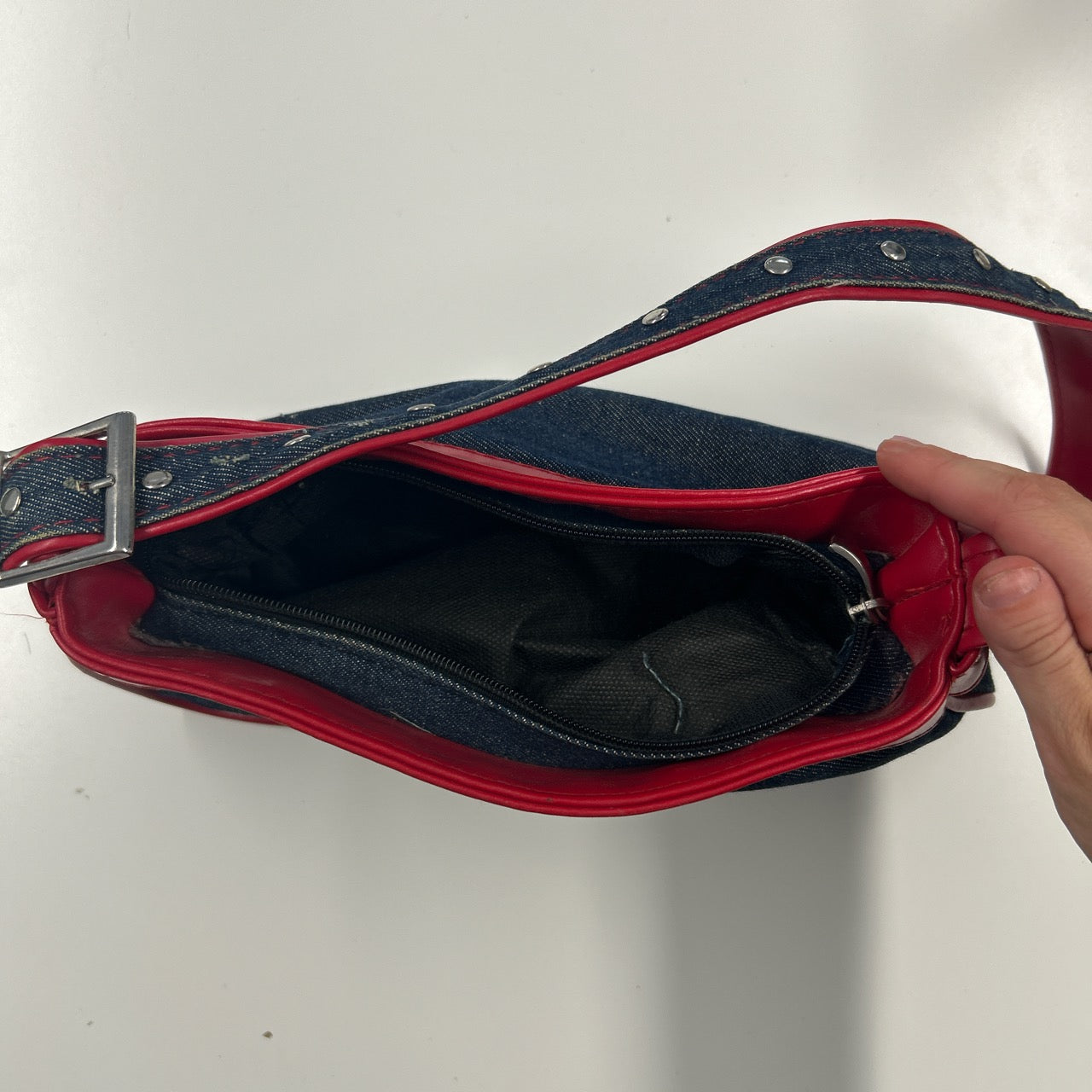 denim and red studded shoulder bag