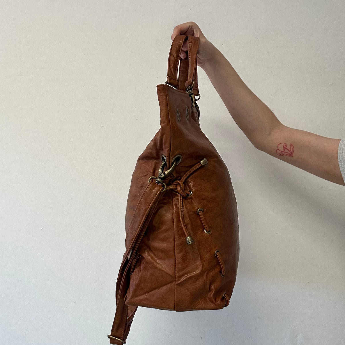 brown eyelet ruched faux leather shoulder bag